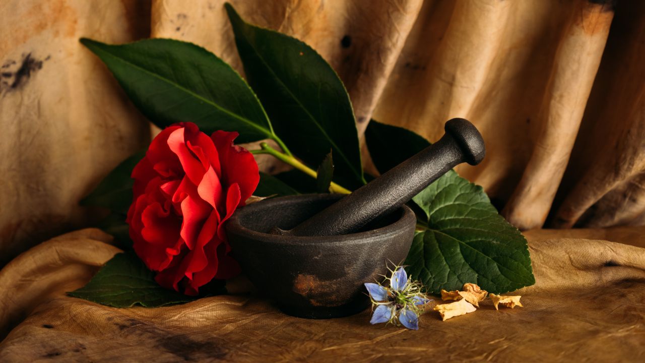 A mortar and pestle with flowers