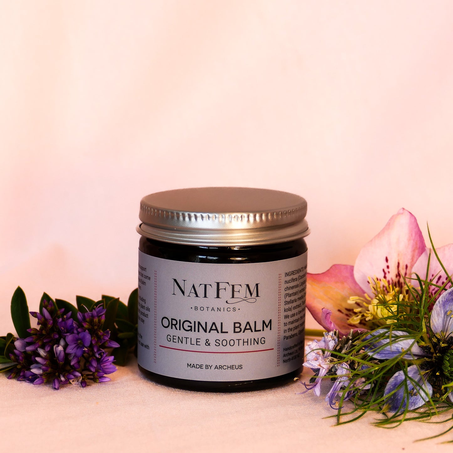 Jar of hormone-free vaginal moisturiser surrounded by flowers